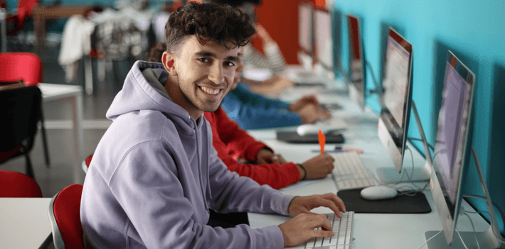 A group of students working on computer during a class in college