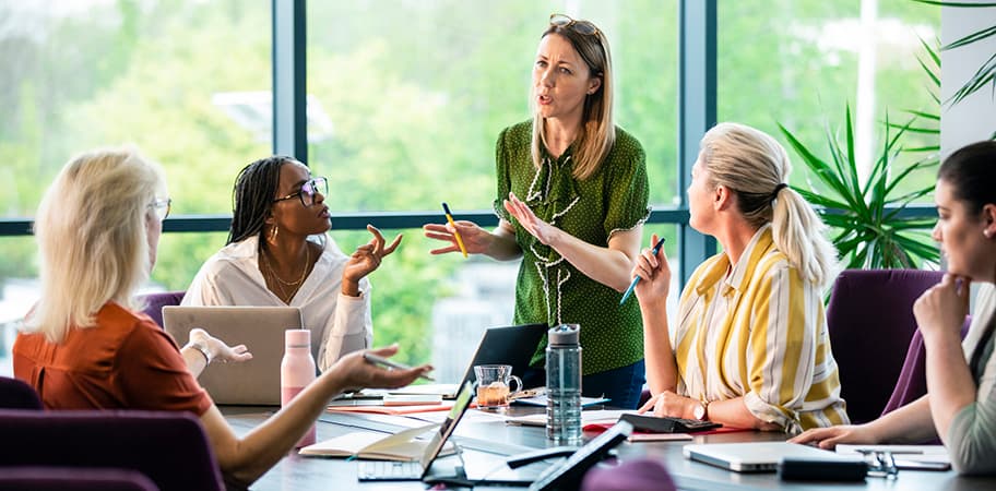 A group of female leaders in a meeting.