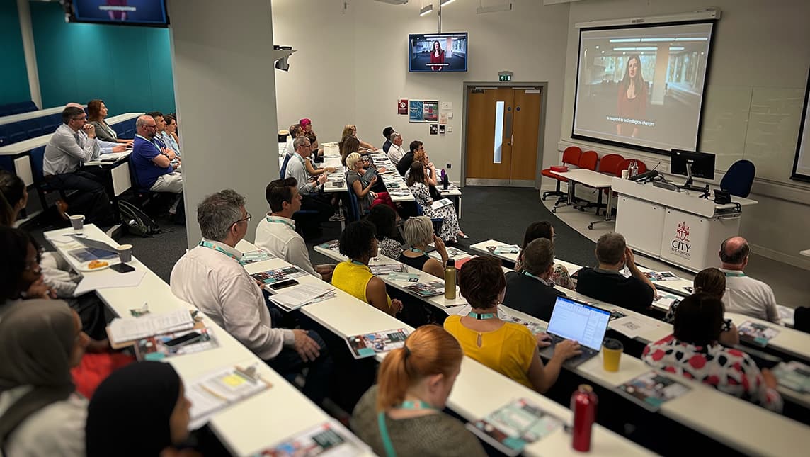 A group of staff listening to a presentation.