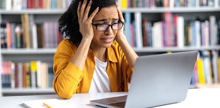 Worried woman looking at a laptop.