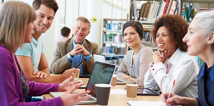 A group of people in a library.