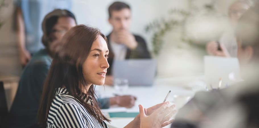 A female staff member talking in a meeting.
