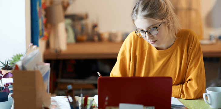 Student working on a laptop at home.
