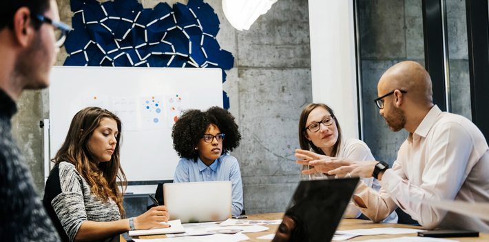 Three women and two men in a business meeting