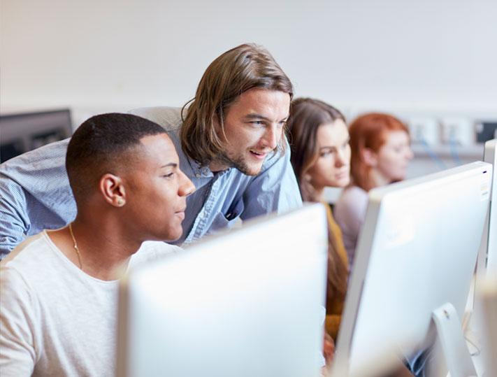 Tutor working with students topbox