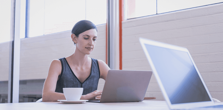 Woman working with laptop in open office