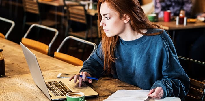 A woman studies in a cafe.